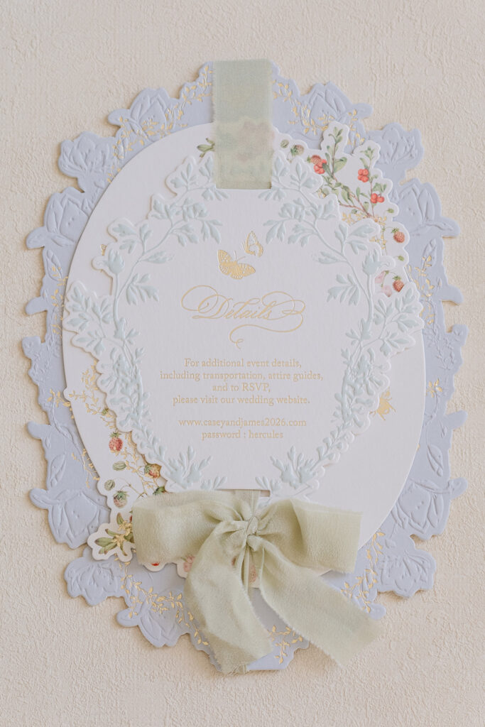 Bespoke wedding invitation with sculpted floral edges, pastel illustration and an ivory ribbon bow.