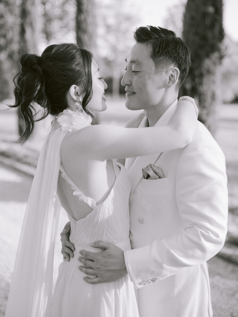Black-and-white portrait of Casey and James embracing during their intimate welcome party at Château de Tourreau.