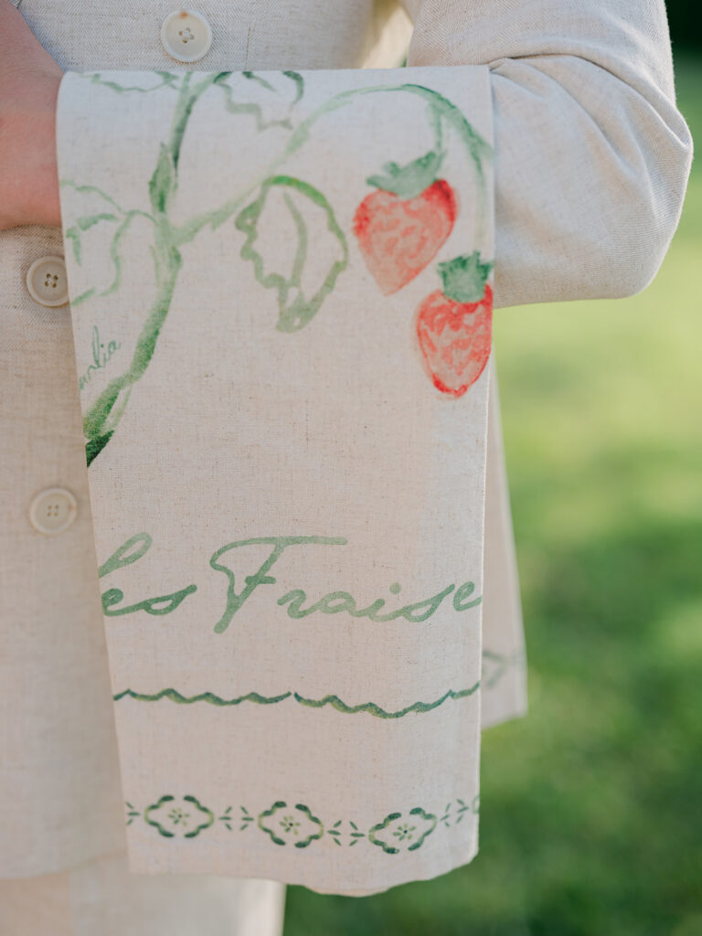 Hand-painted linen napkin with strawberry motifs created for Casey and James’s Provence welcome event.