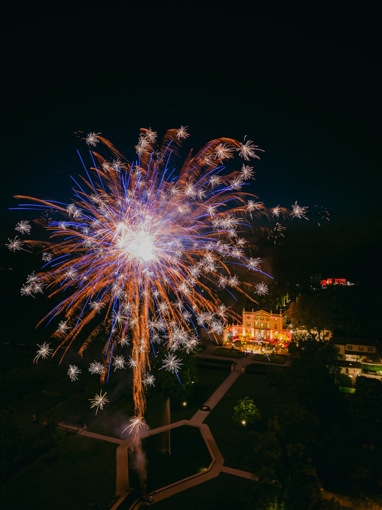 Colourful fireworks illuminate the night sky above Château de Tourreau during Casey and James’s wedding celebration.