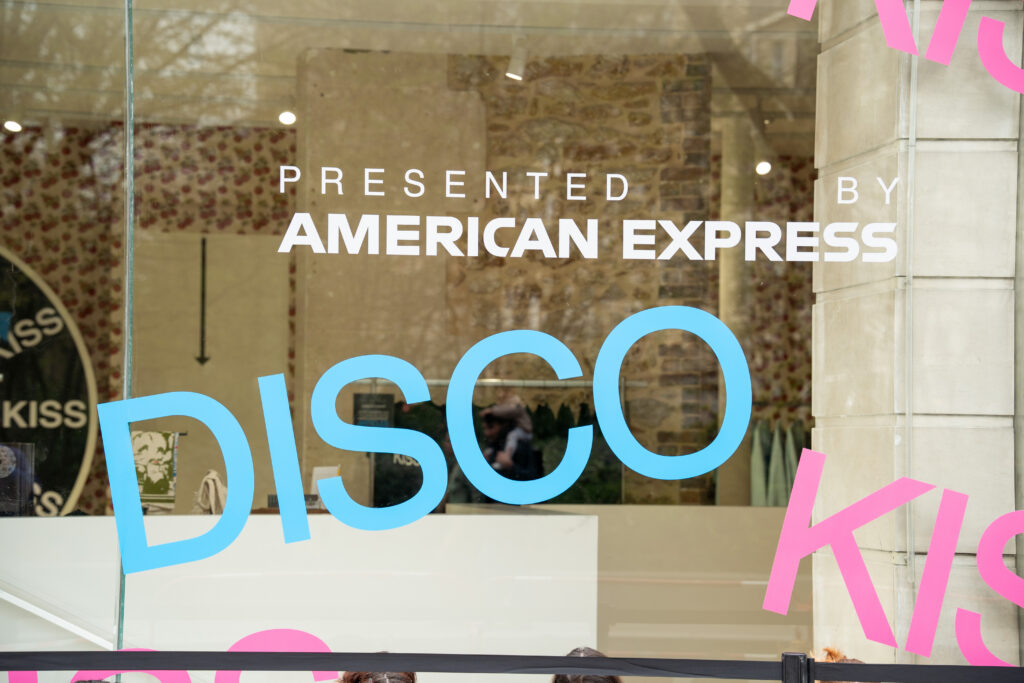 American Express branding and blue Disco lettering on the storefront of Harry Styles' Paris album launch.