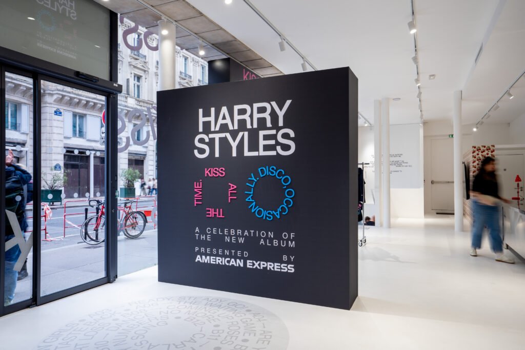 Harry Styles album celebration sign by American Express at the entrance to the Paris pop-up.